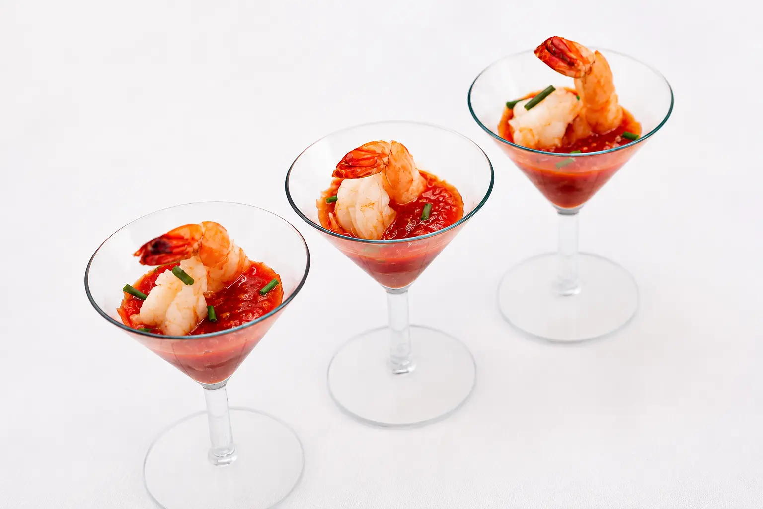 Individual shrimp cocktail served in martini glasses