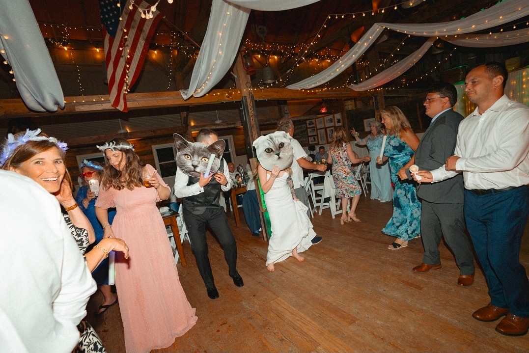 Guests on the dance floor at a barn wedding reception