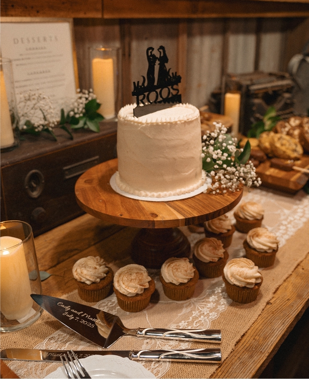 Two-tier wedding cutting cake with cupcakes