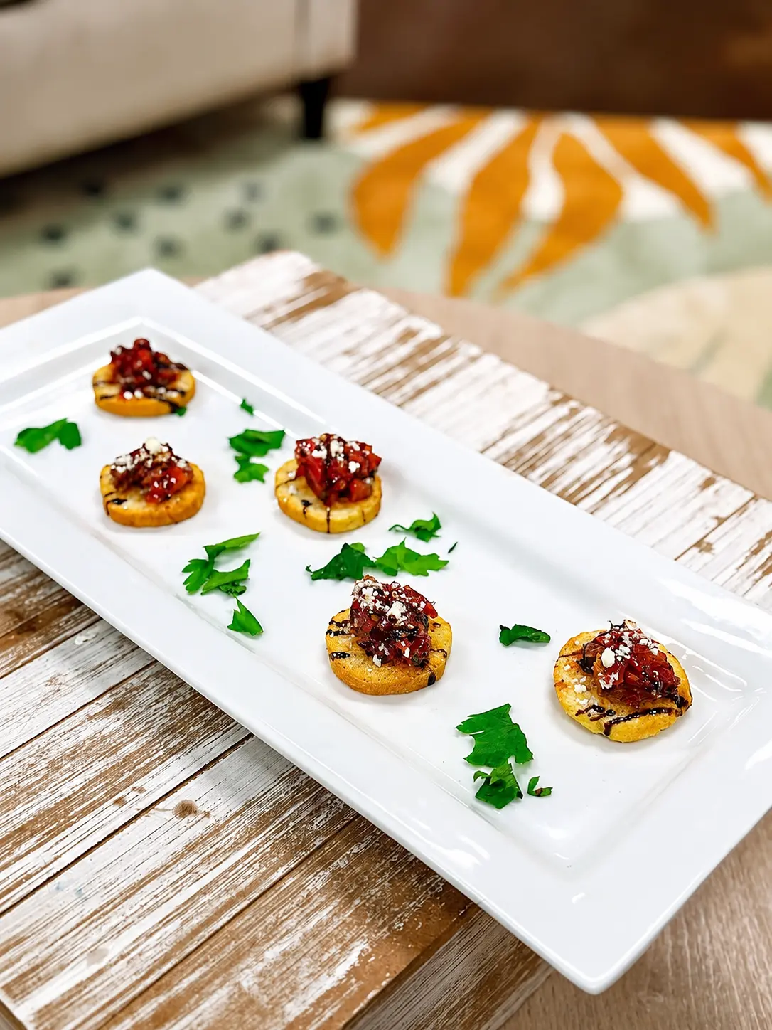 Long platter of bruschetta bites with fresh parsley